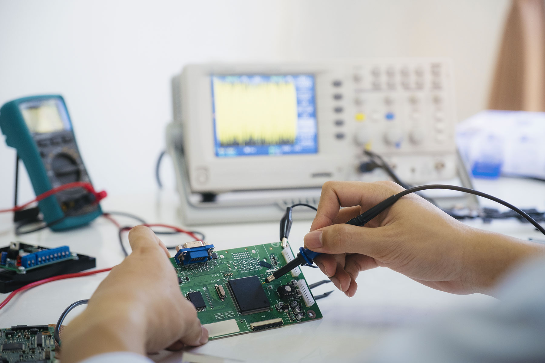 Biomedical technician testing a circuit board